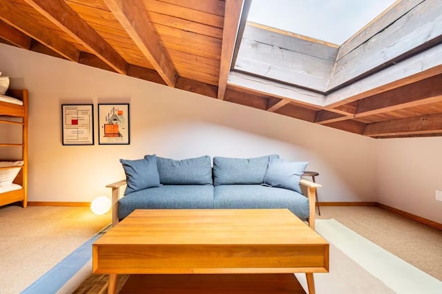 carpeted living room featuring beam ceiling and wooden ceiling