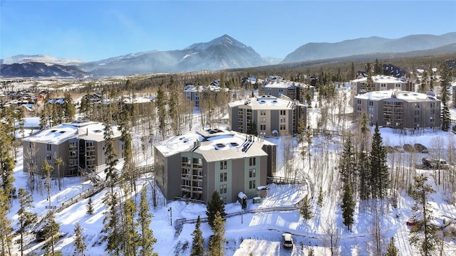 snowy aerial view featuring a mountain view