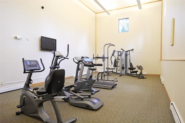 exercise room with a baseboard heating unit