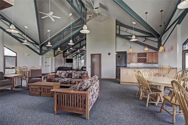 carpeted living room featuring a healthy amount of sunlight and high vaulted ceiling