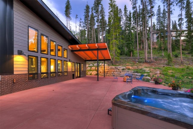 patio terrace at dusk with a hot tub