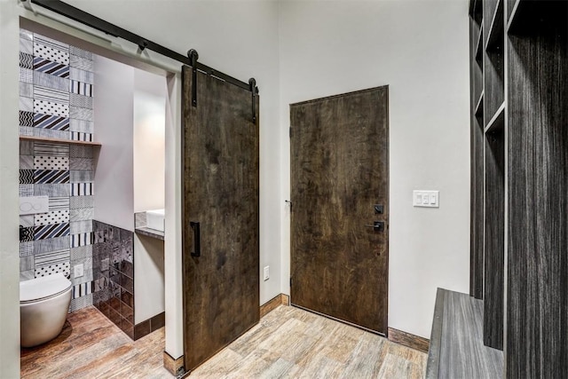 bathroom with hardwood / wood-style floors and toilet