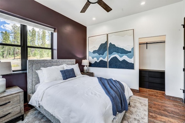 bedroom with ceiling fan, a closet, dark hardwood / wood-style flooring, and multiple windows