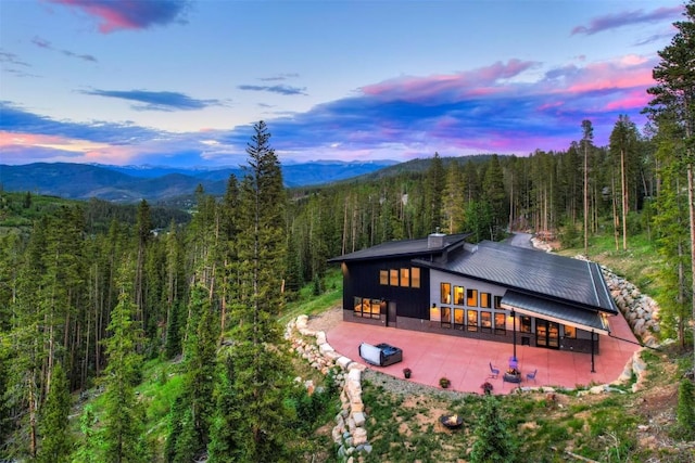 back house at dusk featuring a mountain view