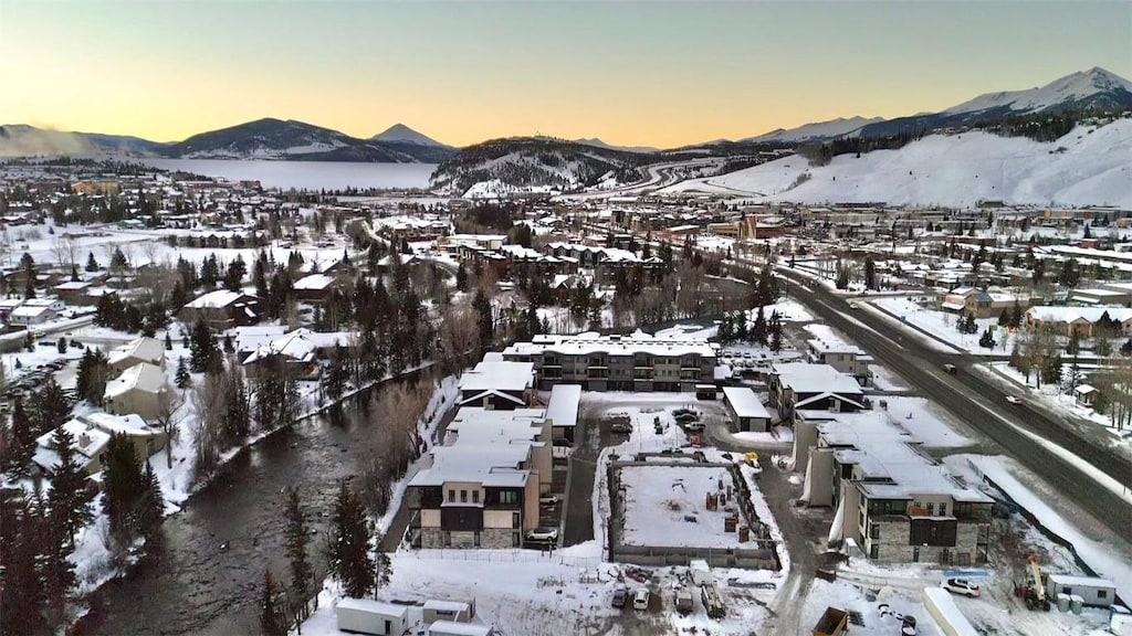 snowy aerial view with a mountain view