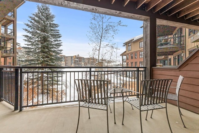 view of snow covered back of property