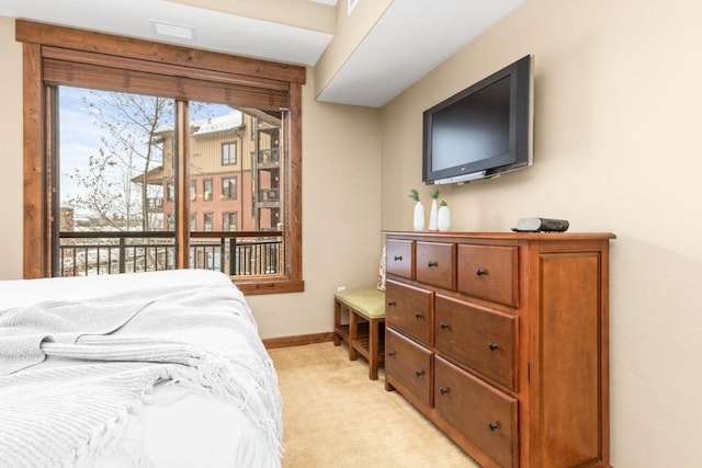 bedroom featuring access to outside and light colored carpet