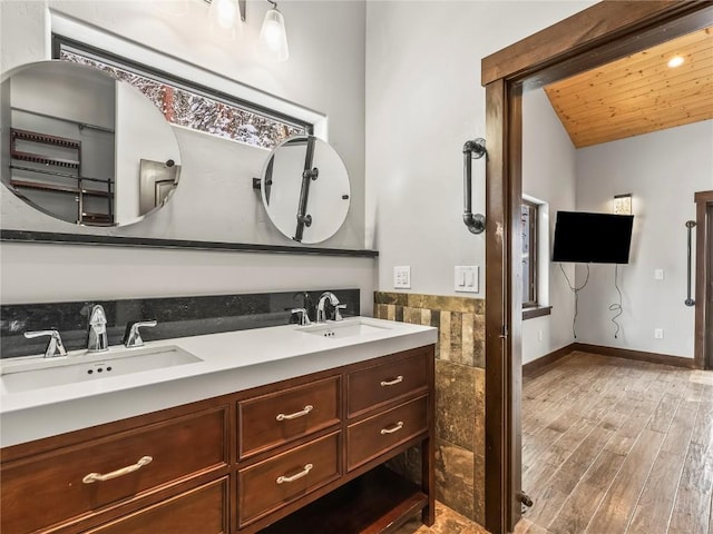 bathroom with wood-type flooring, lofted ceiling, tile walls, vanity, and wooden ceiling