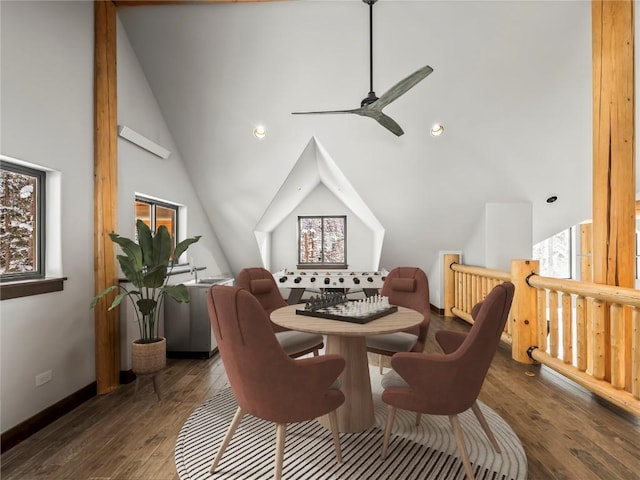 dining area with ceiling fan, dark hardwood / wood-style floors, and high vaulted ceiling