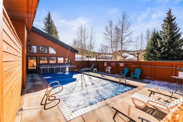 pool featuring a patio and fence