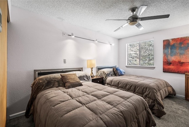 bedroom featuring a textured ceiling, carpet, and a ceiling fan