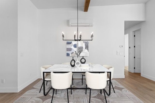 dining space with a wall mounted air conditioner, beam ceiling, light hardwood / wood-style flooring, and a notable chandelier