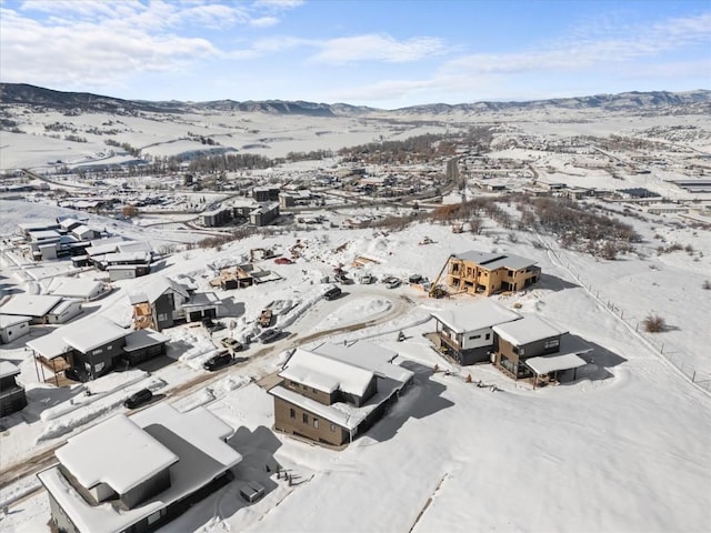 snowy aerial view featuring a mountain view