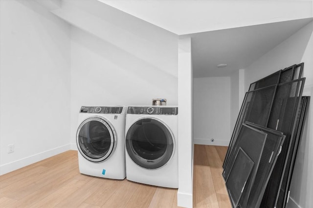 laundry area featuring wood-type flooring and washer and dryer