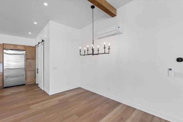 unfurnished dining area featuring beamed ceiling, a barn door, light hardwood / wood-style floors, and a wall unit AC