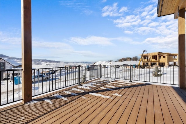 snow covered deck featuring a mountain view