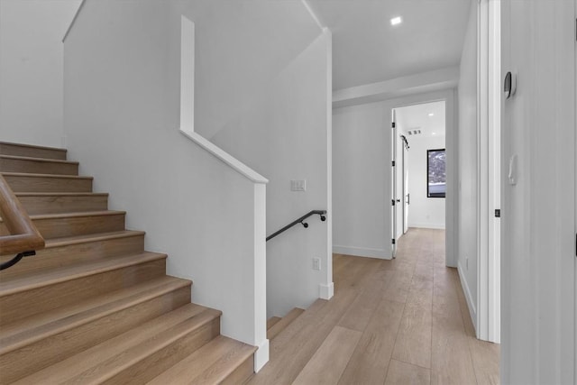 staircase featuring wood-type flooring