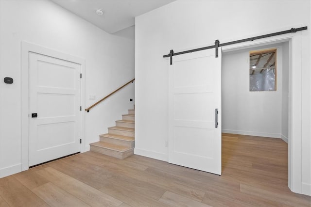 interior space featuring a barn door and light hardwood / wood-style floors