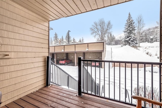 view of snow covered back of property