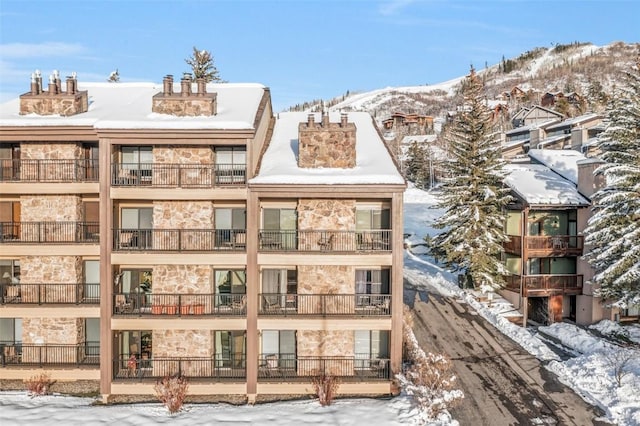 snow covered property with a mountain view