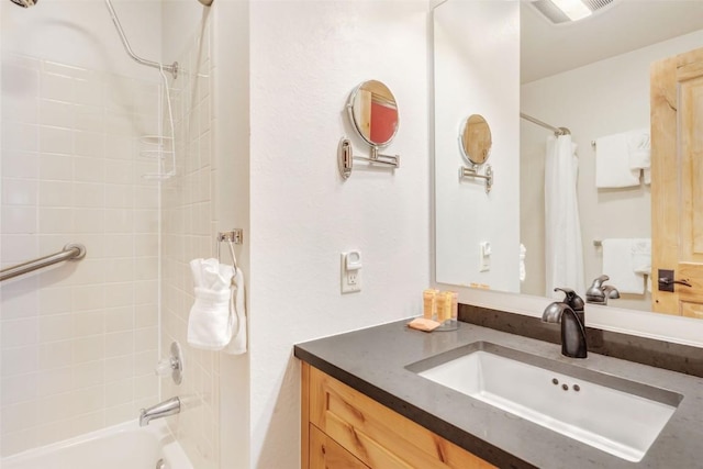 bathroom with shower / tub combo with curtain and vanity