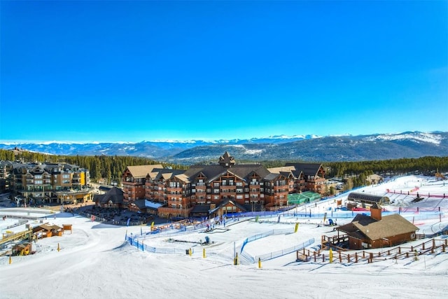 snowy aerial view featuring a mountain view