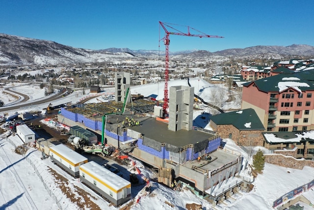 snowy aerial view featuring a mountain view