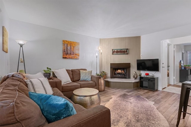 living room with light wood-type flooring and a fireplace