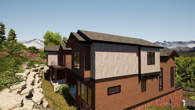 view of home's exterior featuring a balcony and a mountain view