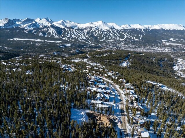 snowy aerial view with a mountain view