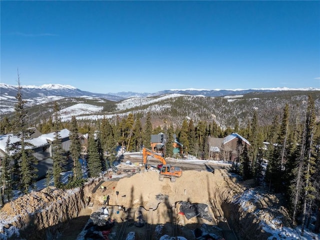 snowy aerial view with a mountain view