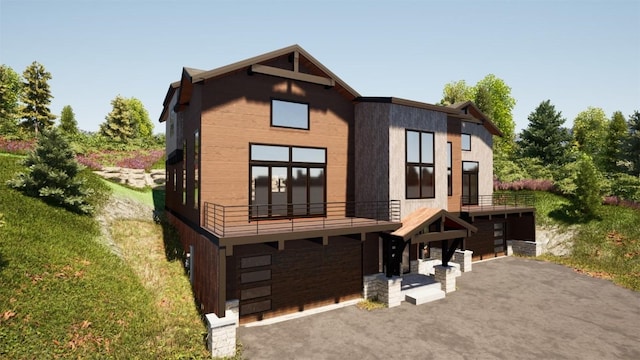 view of front of property with a balcony and a garage