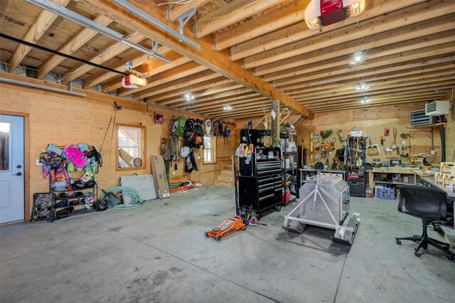 garage with a workshop area and a garage door opener