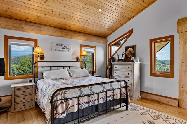 bedroom with light hardwood / wood-style flooring, wooden ceiling, and lofted ceiling