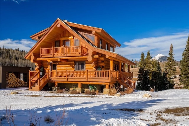 log-style house featuring a balcony