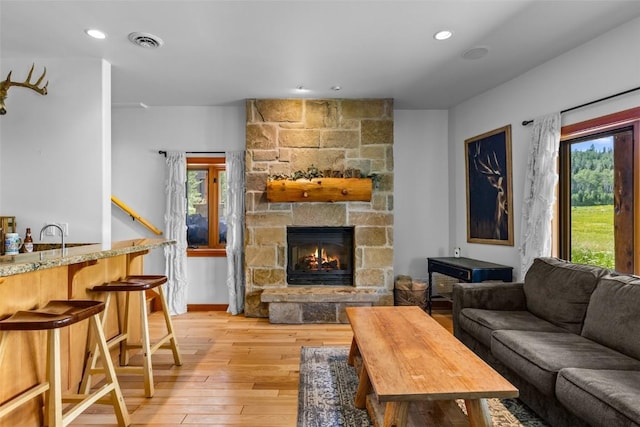 living room with a fireplace and light hardwood / wood-style floors