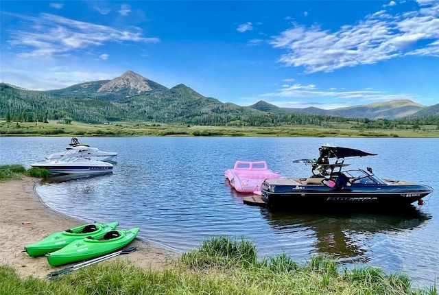 dock area with a water and mountain view