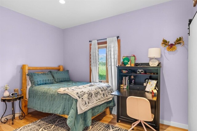 bedroom with hardwood / wood-style floors