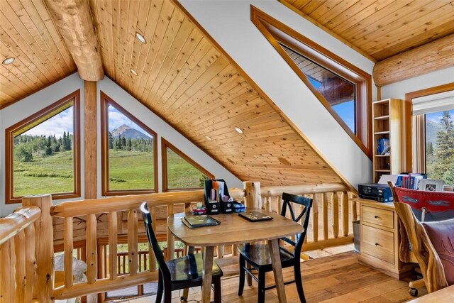 dining area featuring vaulted ceiling with beams, light wood-type flooring, and wooden ceiling