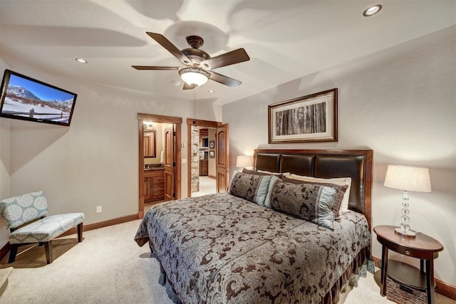 carpeted bedroom with ceiling fan and ensuite bath