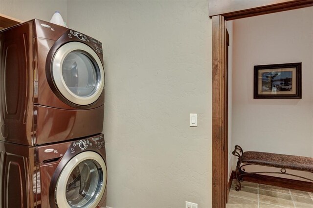 clothes washing area featuring stacked washer / drying machine