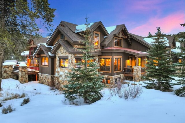 view of snow covered back of property