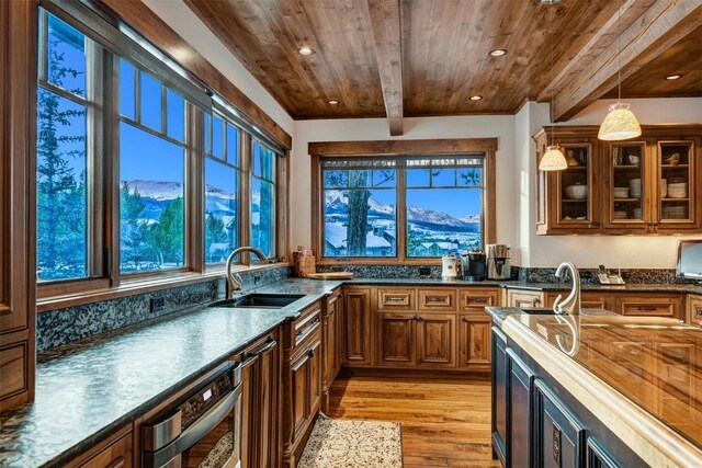 kitchen with plenty of natural light, beamed ceiling, wooden ceiling, and light wood-type flooring