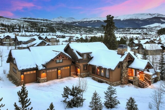 snowy aerial view featuring a mountain view