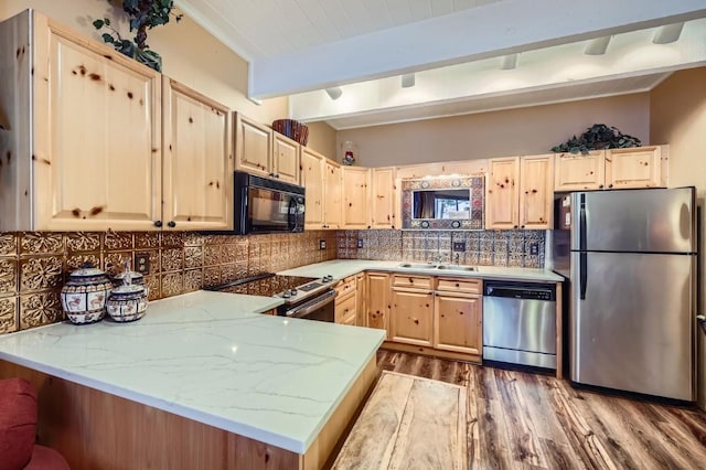 kitchen featuring sink, light brown cabinets, appliances with stainless steel finishes, kitchen peninsula, and backsplash