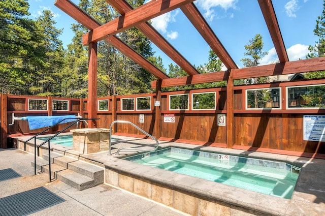 view of swimming pool featuring a community hot tub