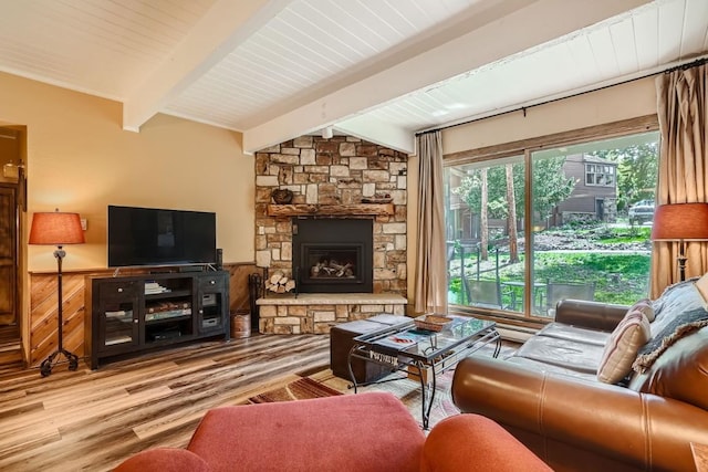 living room featuring a fireplace, light hardwood / wood-style flooring, and vaulted ceiling with beams