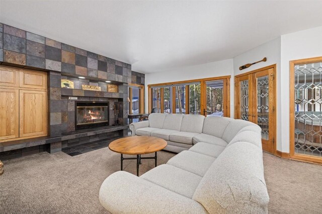 living room with a fireplace and carpet