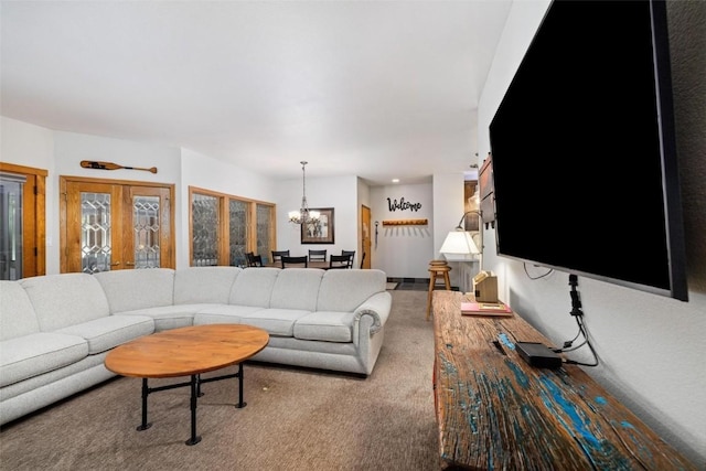 living room featuring french doors, light colored carpet, and a chandelier