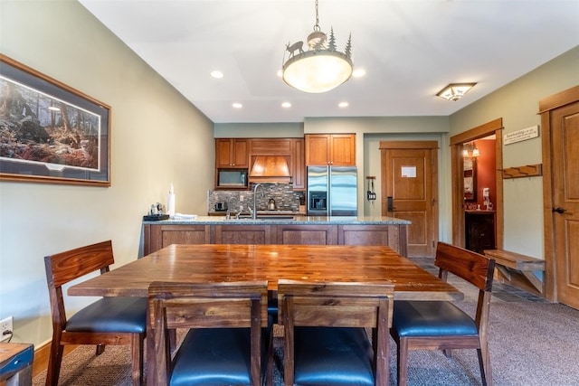 kitchen with carpet, stainless steel fridge, tasteful backsplash, built in microwave, and sink